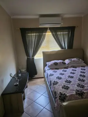 a bedroom with a bed and a window at Peters Place