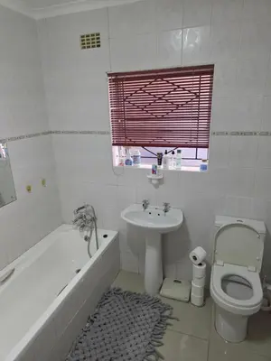 a bathroom with a sink and a toilet and a bath tub at Peters Place