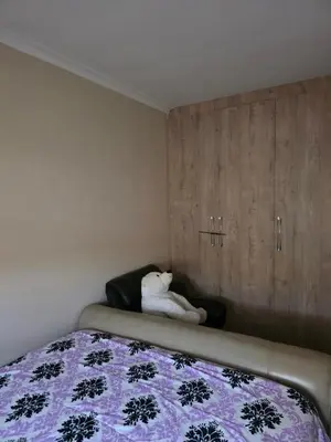 a white teddy bear sitting on a bed in a bedroom at Peters Place