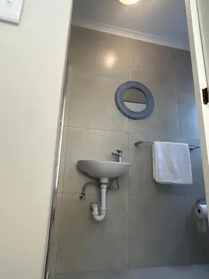 a bathroom with a sink and a mirror at Immaculate,Alttrative &Modern 6 minutes away from the beach in Cape Town