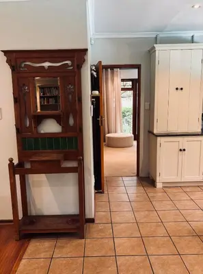 a kitchen with a counter and a door to a room at Family home with table mountain view and pool in Stellenbosch