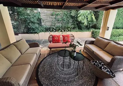 a patio with two couches and a table at Family home with table mountain view and pool in Stellenbosch