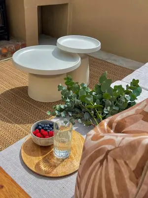 a table with a glass of water and a bowl of fruit at Mountain views oasis in Franschhoek