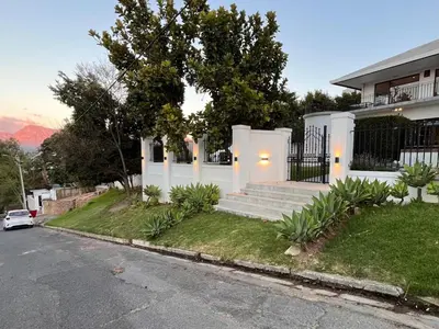 a house on a street with a driveway at Durr's Nest - Central Paarl Mountain Retreat in Paarl