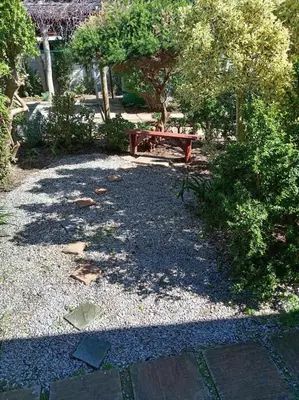 a park with a picnic table in a garden at Paul's Place in Fisherhaven