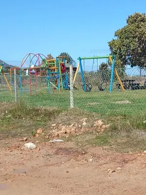 a park with a playground in a field at Paul's Place in Fisherhaven