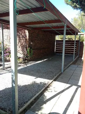 a garage with awning and a brick building at Paul's Place in Fisherhaven