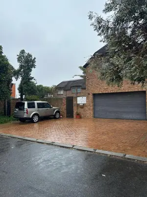 a car parked in front of a garage at Daisy Accommodation & Spa in Cape Town