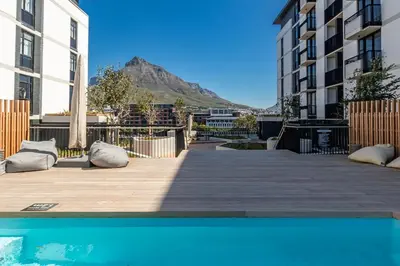 a view from the pool in a apartment with a mountain in the background at Riverlands, Observatory, Luxury 1 Bed with views in Cape Town