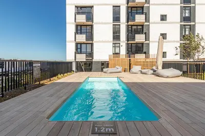 a swimming pool on the roof of a building at Riverlands, Observatory, Luxury 1 Bed with views in Cape Town