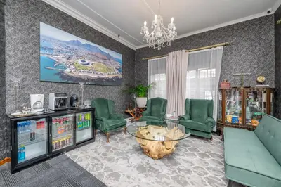 a living room with green chairs and a video game at Self Contained 2 bed Room Condo in Parow