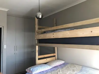 a bedroom with two bunk beds at Cape on Porterfield in Cape Town