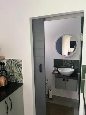 a bathroom with a sink and a mirror at carol close1 small apartment in Eversdal