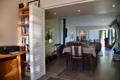 a dining room with a table and chairs and a room with a dining room at The Modest Mansion in Cape Town