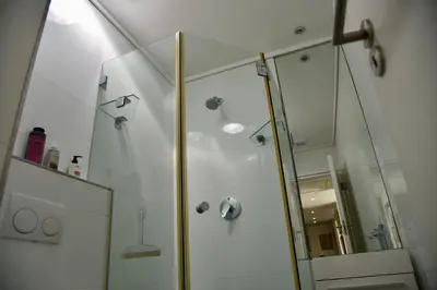 a shower with a glass door in a bathroom at The Modest Mansion in Cape Town