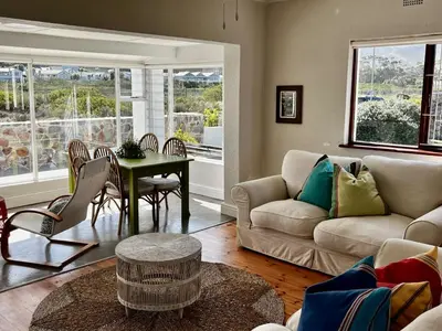 a living room with a couch and a table at Cali House, Kwaaiwater Getaway in Hermanus