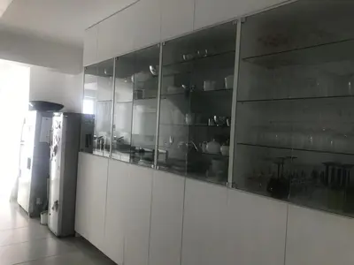a kitchen with white cabinets and a refrigerator at Luxury Family Home in Helderberg
