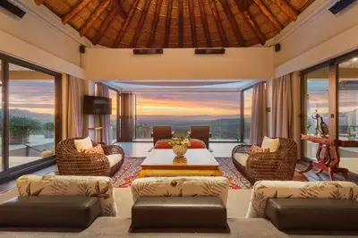 a living room with a table and chairs at Villa Bezweni in Somerset West
