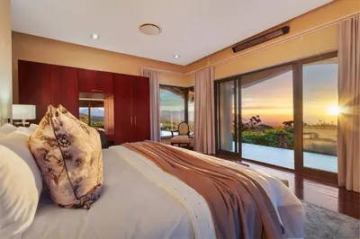 a bedroom with a large bed and a large window at Villa Bezweni in Somerset West