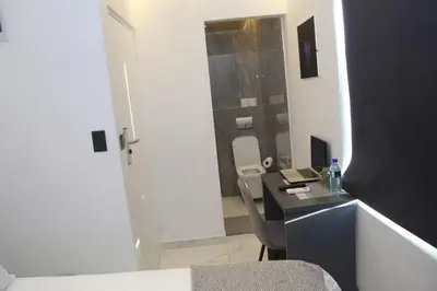 a bathroom with a sink and a desk with a mirror at Willow Brooks in Cape Town