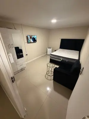 a small room with a bed and a couch at Joy House in Cape Town