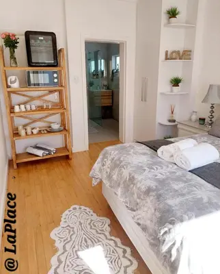 a bedroom with a bed and a television in it at LaPlace in Strand