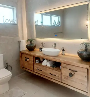 a bathroom with a sink and a mirror at LaPlace in Strand