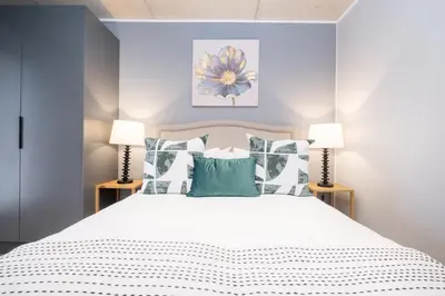 a bedroom with a large white bed with pillows at 410 Riverlands - Lux 1 bedroom Apartment in Cape Town