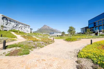 a brick pathway with a mountain in the background at 410 Riverlands - Lux 1 bedroom Apartment in Cape Town