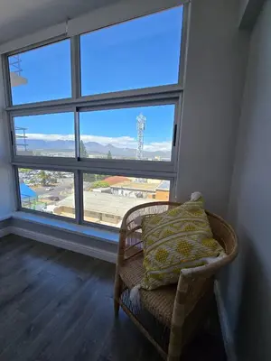 a chair in a room with a large window at Panorama Sea and Mountain Views in Strand