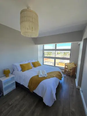 a bedroom with a bed with two towels on it at Panorama Sea and Mountain Views in Strand
