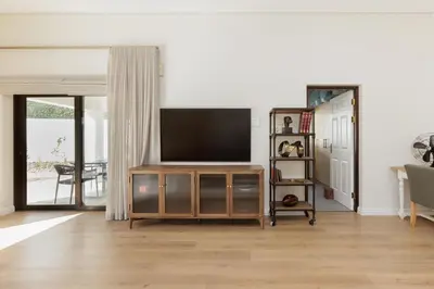 a living room with a flat screen tv on a wall at Villa Canetsfontein in Wellington