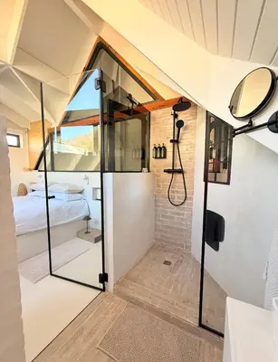 a bathroom with a shower and a bed in a room at Tranquille Haven - serene escape in Franschhoek in Franschhoek