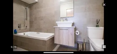 a bathroom with a tub and a sink and a toilet at Waters Edge Sanctuary in Cape Town