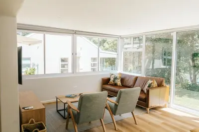 a living room with a couch and a table at Patryssenvalleij Farm and Cottages in Stellenbosch