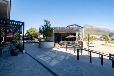 a building with a restaurant on a city street at 714 Riverlands - Lux Studio Apartment in Cape Town