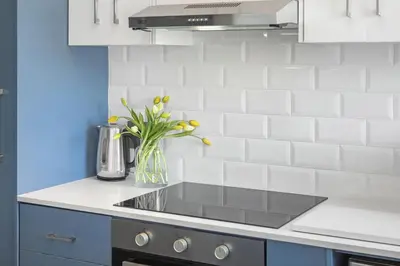a kitchen with a sink and a vase of flowers at 17 Megans Place in Bloubergstrand