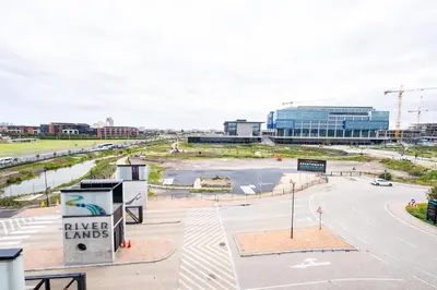 an empty street with a building in the background at 309 Riverlands - Lux 1 Bedroom Apartment in Cape Town