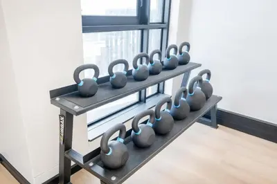 a row of dumbbells on a rack in a gym at 309 Riverlands - Lux 1 Bedroom Apartment in Cape Town