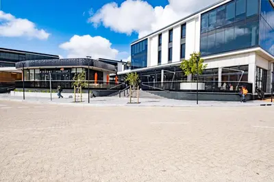 a large building with trees in front of it at 309 Riverlands - Lux 1 Bedroom Apartment in Cape Town
