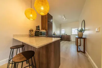 a kitchen with two bar stools and a counter top at The Nest Franschhoek in Franschhoek