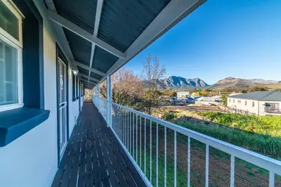 a balcony with a view of the mountains at The Nest Franschhoek in Franschhoek