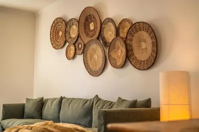a living room with four copper plates on the wall at The Nest Franschhoek in Franschhoek