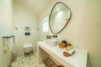 a bathroom with a sink and a mirror on the wall at The Nest Franschhoek in Franschhoek