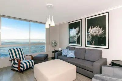 a living room with a couch and a chair at 706 Odeon Towers - Ocean Splendour in Strand