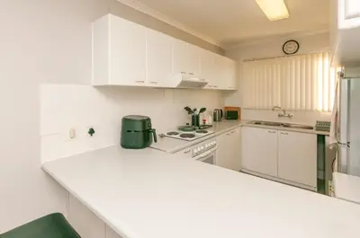 a kitchen with white cabinets and a white counter top at 706 Odeon Towers - Ocean Splendour in Strand