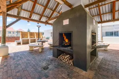 a large fireplace in a patio with a fire place at 706 Odeon Towers - Ocean Splendour in Strand