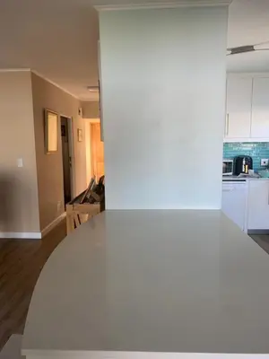 an empty living room and kitchen with a white wall at Cape Town in Cape Town