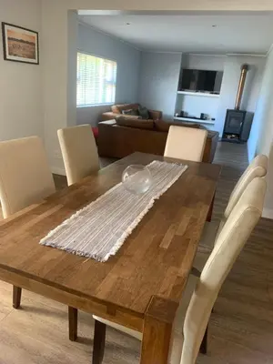 a dining room table with chairs and a couch at Cape Town in Cape Town