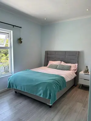 a bedroom with a bed in a room with a window at Cape Town in Cape Town